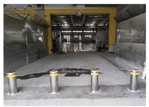 Hydraulic rising bollards at an industrial logistics entrance