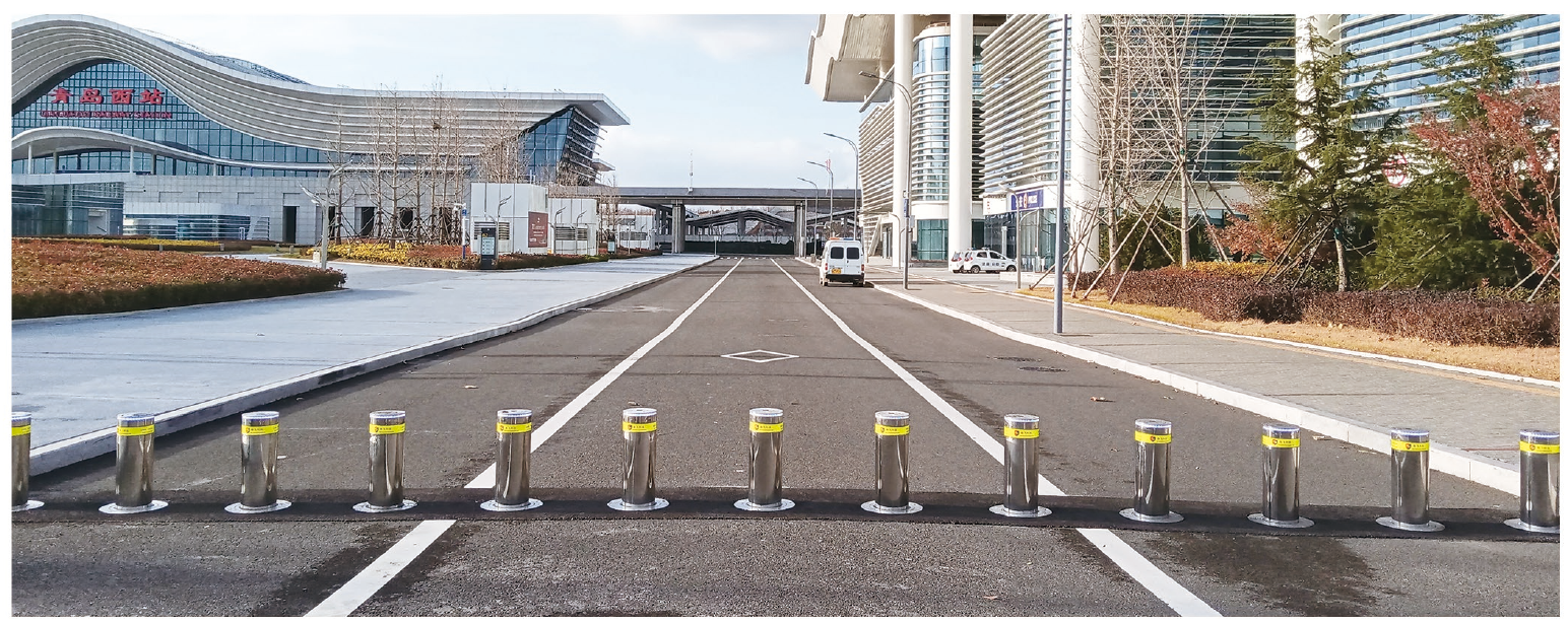 Completed rising bollard deployment across a transport hub vehicle lane
