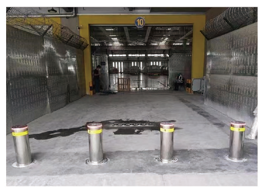 Hydraulic rising bollards at an industrial logistics entrance