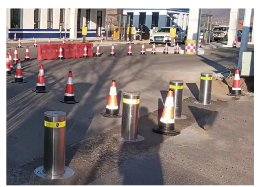 Automatic rising bollards at an industrial vehicle entrance