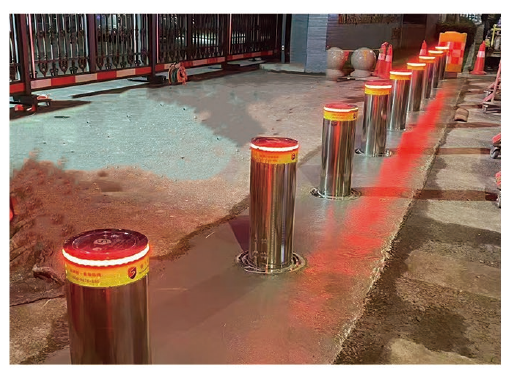 Automatic rising bollards with illuminated LED warning lights during testing